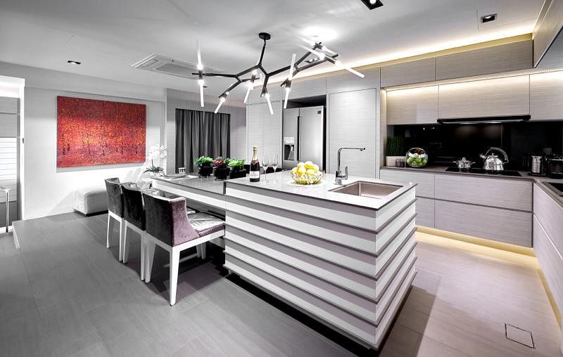 饭厅兼厨房有一盏垂挂天花板的黑白设计吊灯，配合一面墙上的画作，增添了厨房的现代感。