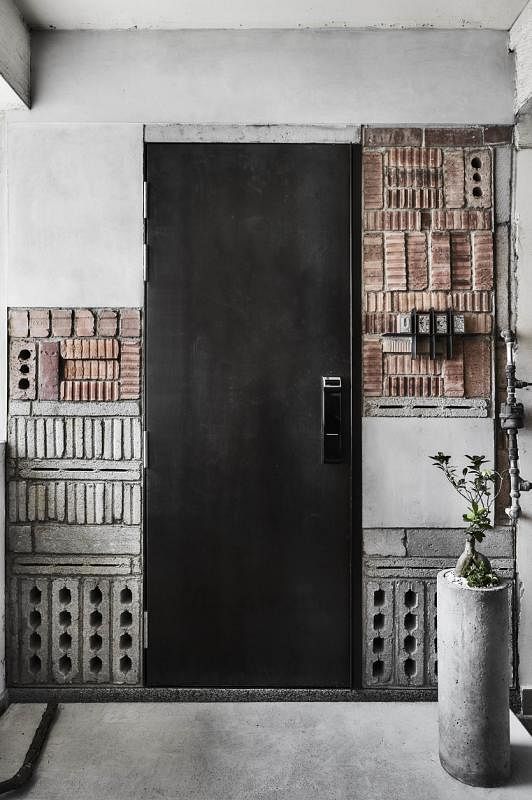 组屋的黑色铁门有种工业酷感，没有铁闸，靠电子门锁进入。