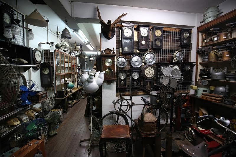古董店二楼收藏着大件的磁盘、书画、挂钟、脚踏车等。