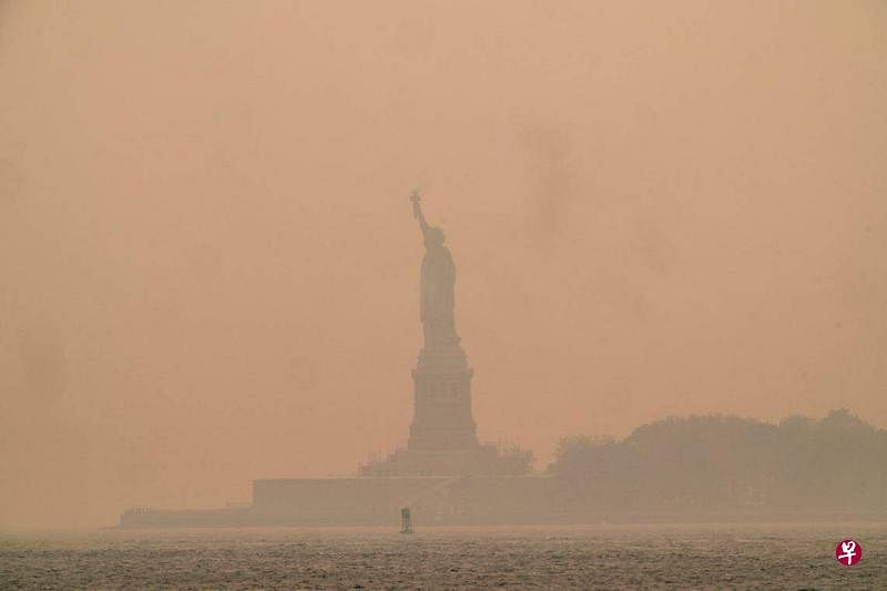 美国纽约市笼罩在烟霾中。6月7日的照片显示，远眺看不清在纽约市上湾的自由女神像。（法新社）