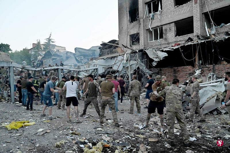 乌东城市克拉玛托斯克遭俄军导弹袭击，一家餐厅被夷为平地，已有至少10人遇难，另有61人受伤。图为救援人员和志愿者在废墟中搜救。（法新社）