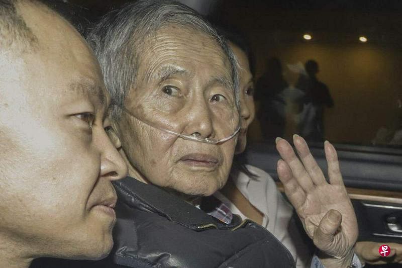 秘鲁前总统藤森谦也（左二）星期三（12月6日）离开利马东部郊区的巴巴迪略（Barbadillo）监狱时，支持者和记者推挤到载送他的汽车周围。（法新社）
