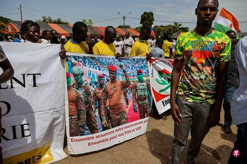 布基纳法索2022年经历了两次军事政变。9月29日，军政府支持者在政变一周年的集会上，举着印有政变领导人易卜拉欣·特拉奥雷照片的横幅。（路透社）